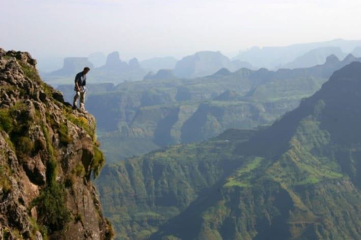 Mountain climber overlooking the Sanakber valley in the Simien Mountains Ethiopia